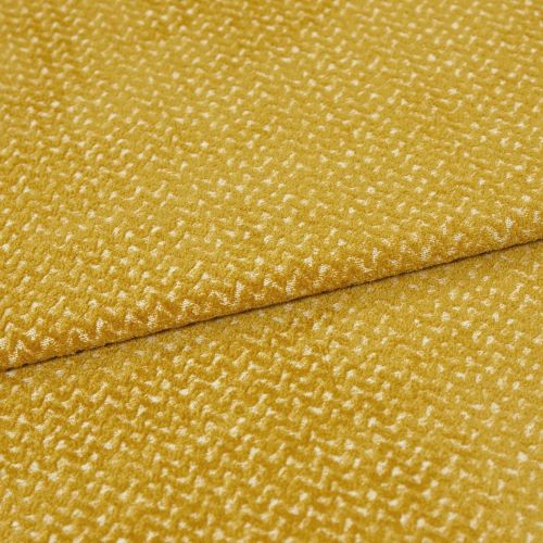 golden-yellow textured upholstery fabric folded diagonally, overlapping seam visible; short plush pile creates a mottled sheen, presented in a tight close-up under soft, even studio lighting.