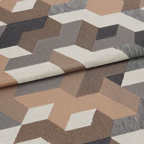 Woven fabric with folded edge, geometric 3D cube pattern in beige, gray, cream and brown; lying flat and slightly overlapped, close-up showing textured weave under soft, neutral lighting.