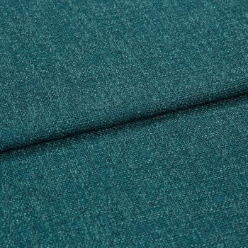 Teal woven upholstery fabric, close-up of a folded seam showing textured boucle-like weave; the fabric is folded diagonally across the frame, lit evenly in soft studio lighting.