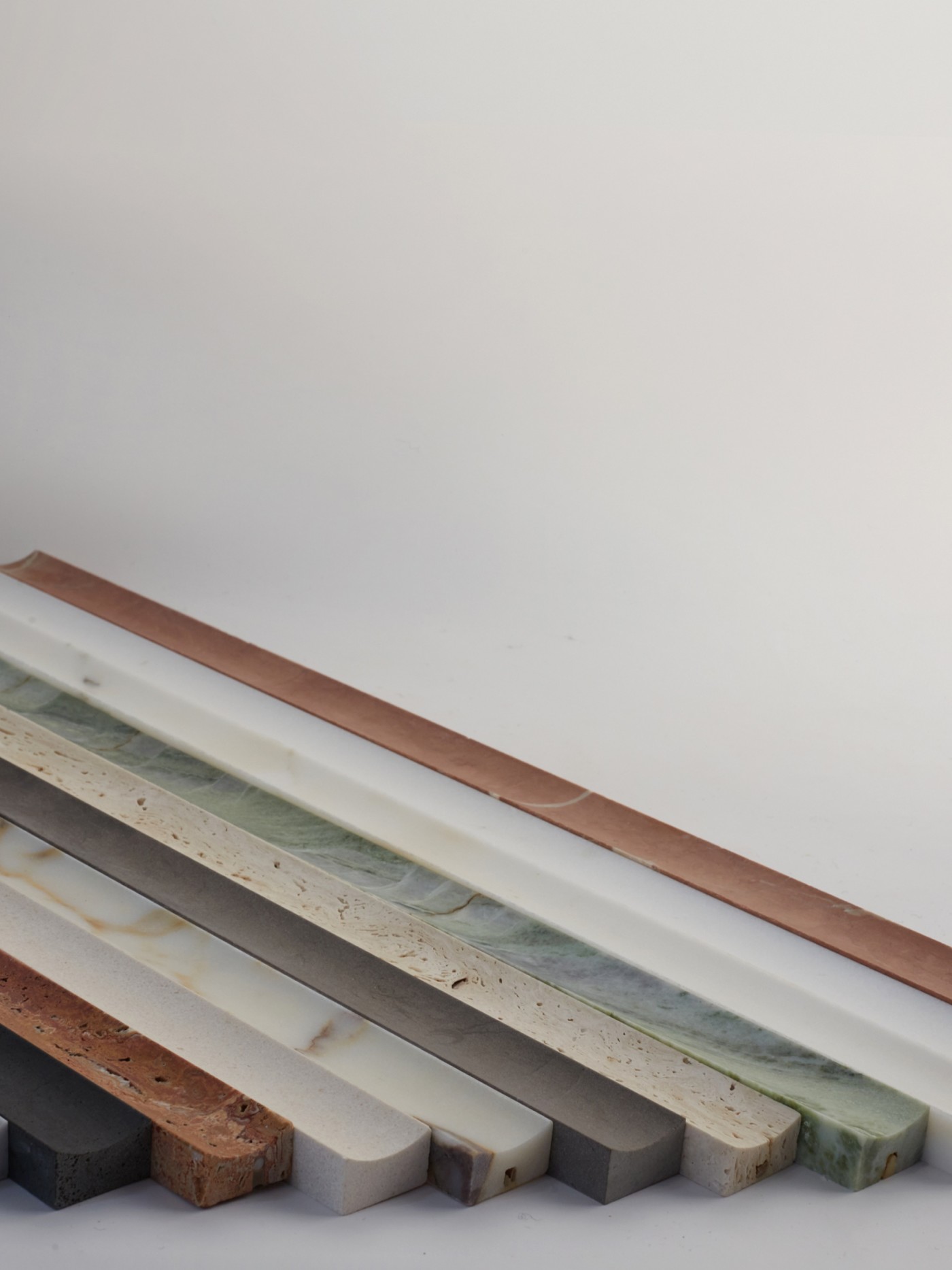 a row of different colored marble slabs on a white surface.