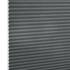 Gray cellular (honeycomb) blind, fully lowered with horizontal pleats and exposed honeycomb edges at left, blocking light; close-up studio view against a white background.
