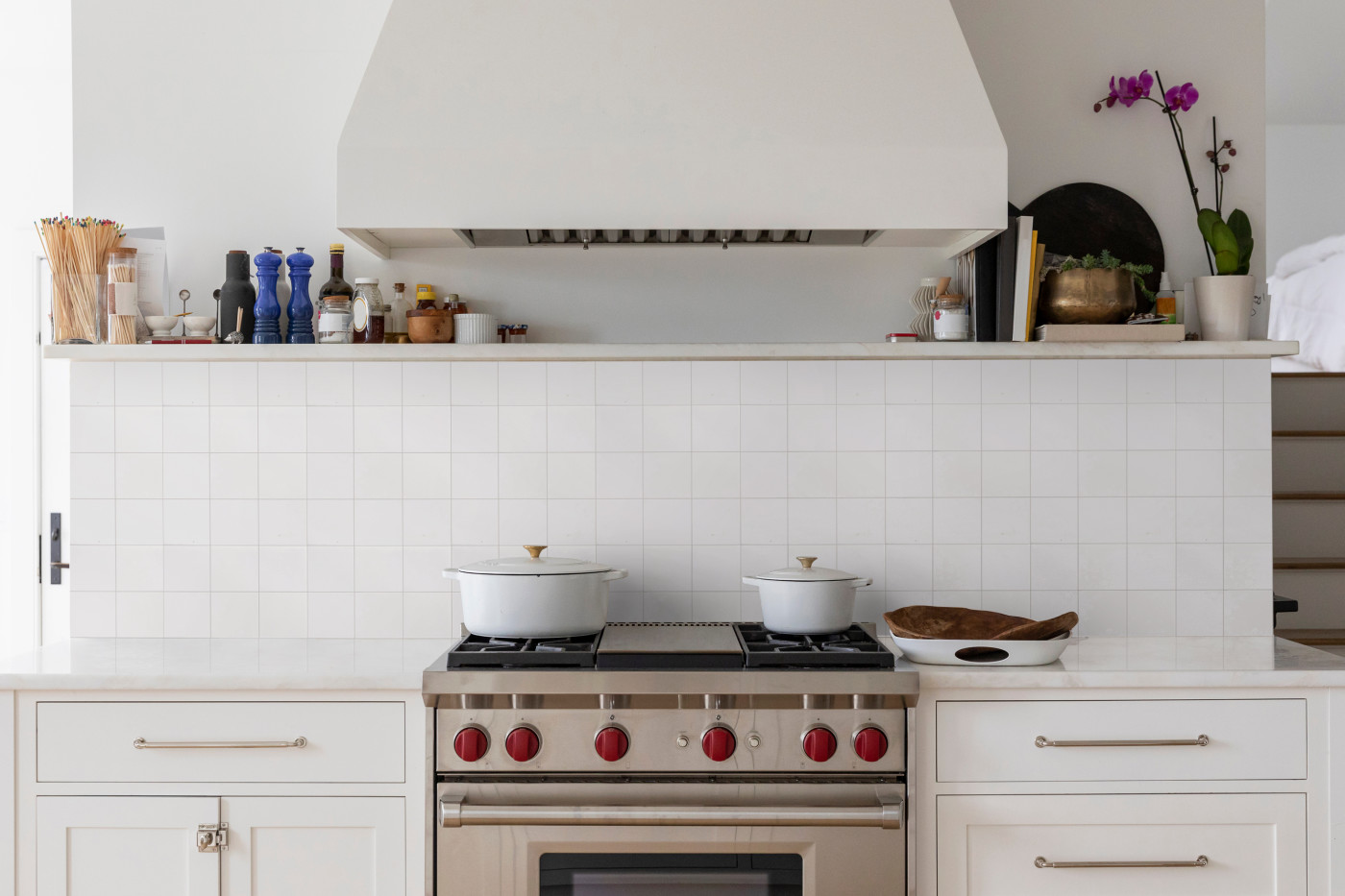 a white kitchen with a stove and oven.