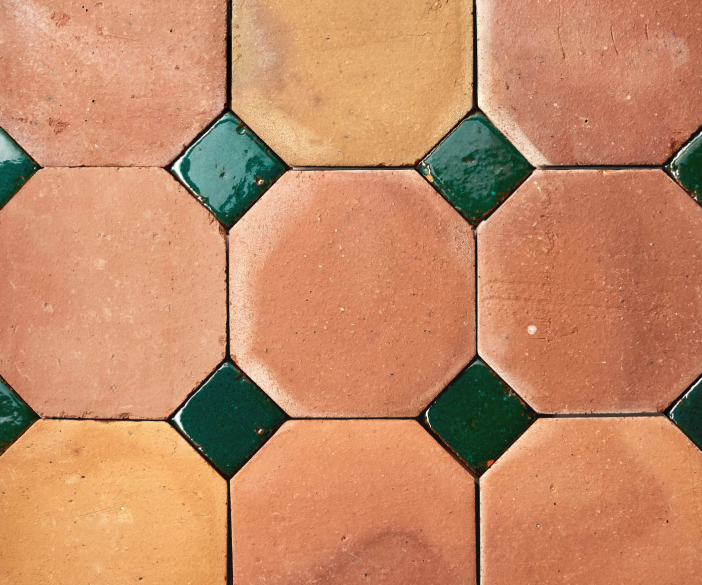 a close up of green and orange tiles arranged in a pattern.