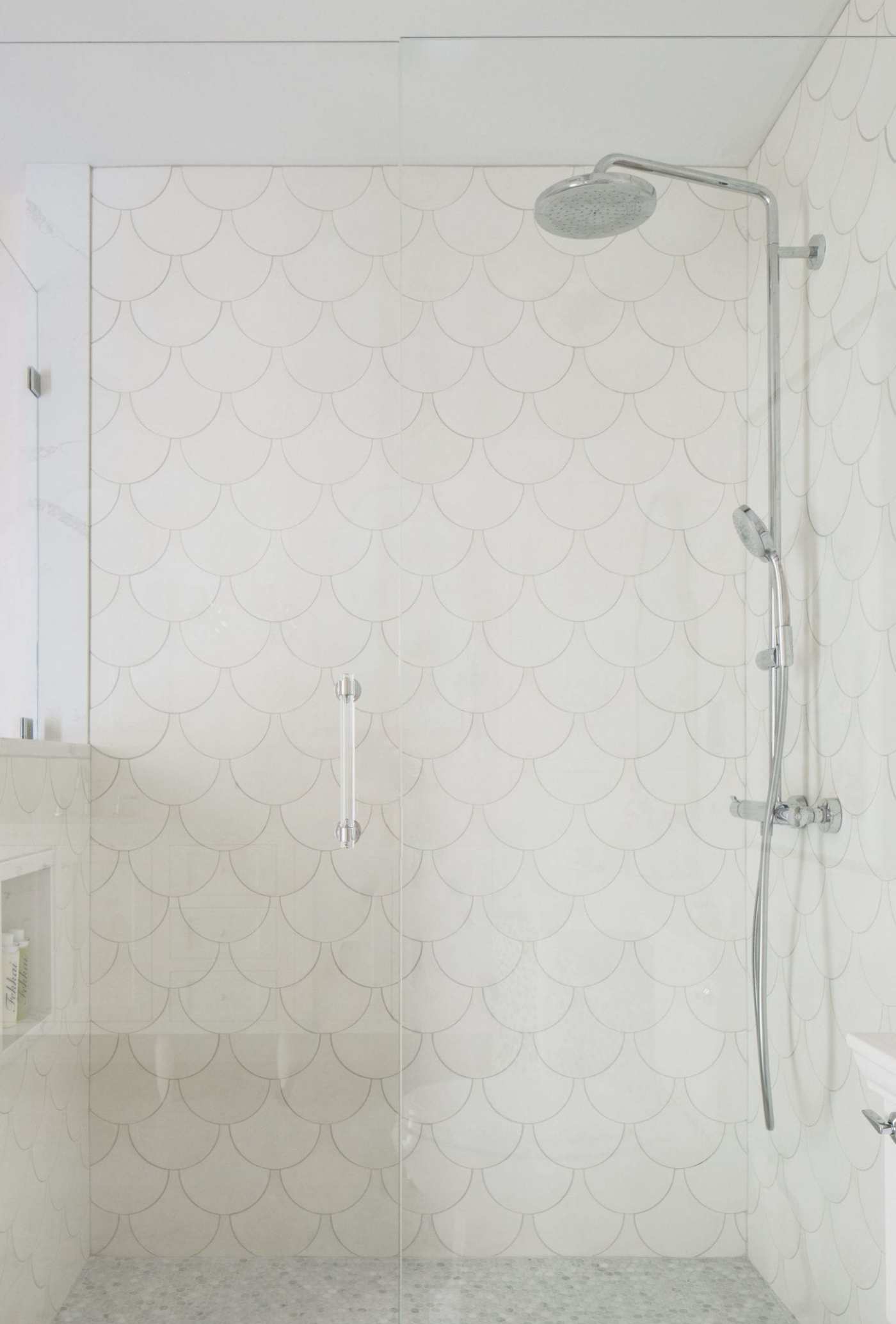 a white bathroom with a glass shower stall.