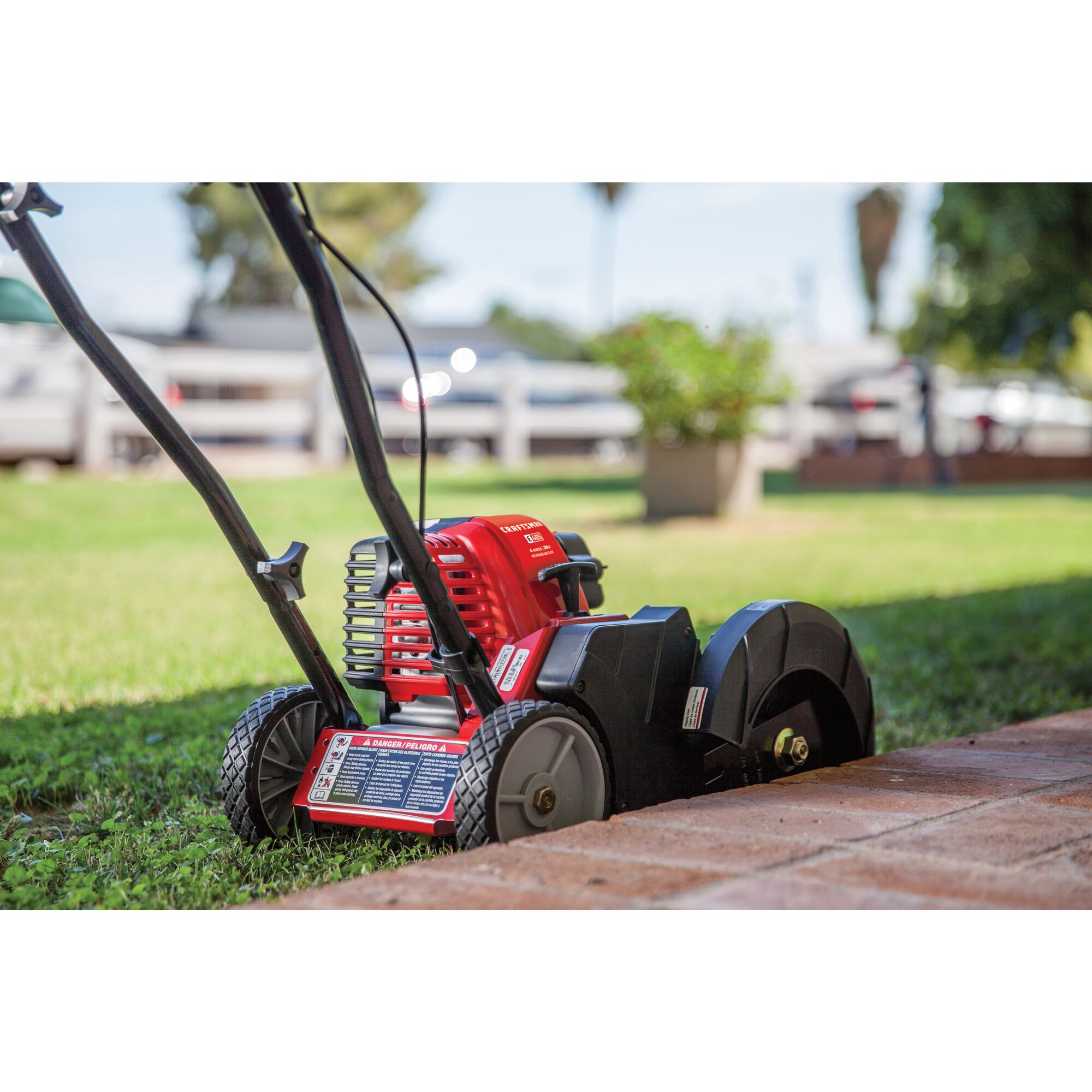 CRAFTSMAN E405 Gas Edger zoomed out edging grass near brick