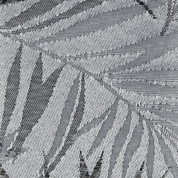 Sheer woven curtain panel hung over a window, showing stylized palm-leaf jacquard in light and dark threads; backlit close-up revealing textured, neutral-toned fabric.