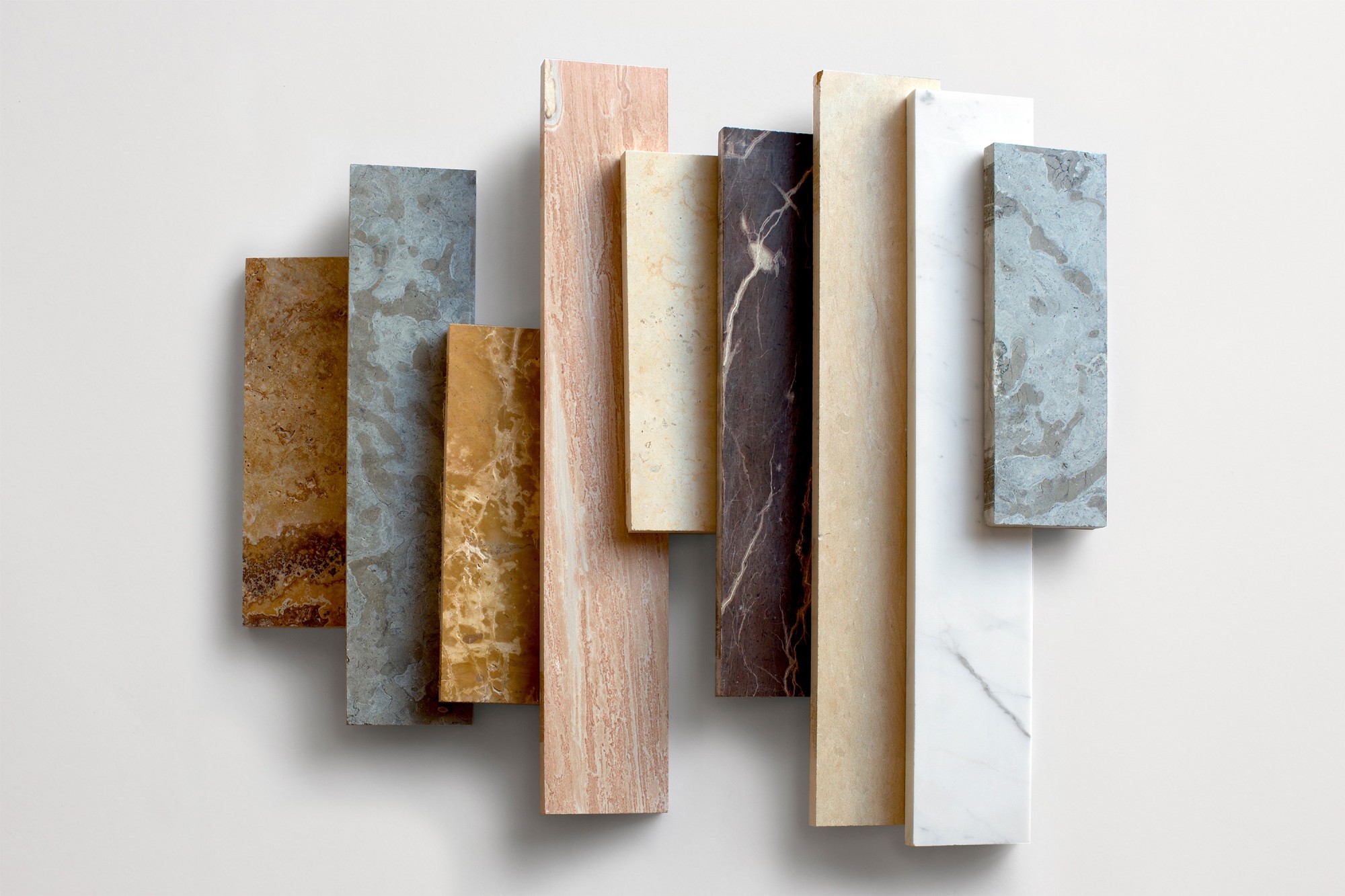 a group of different colored marble tiles on a white surface.