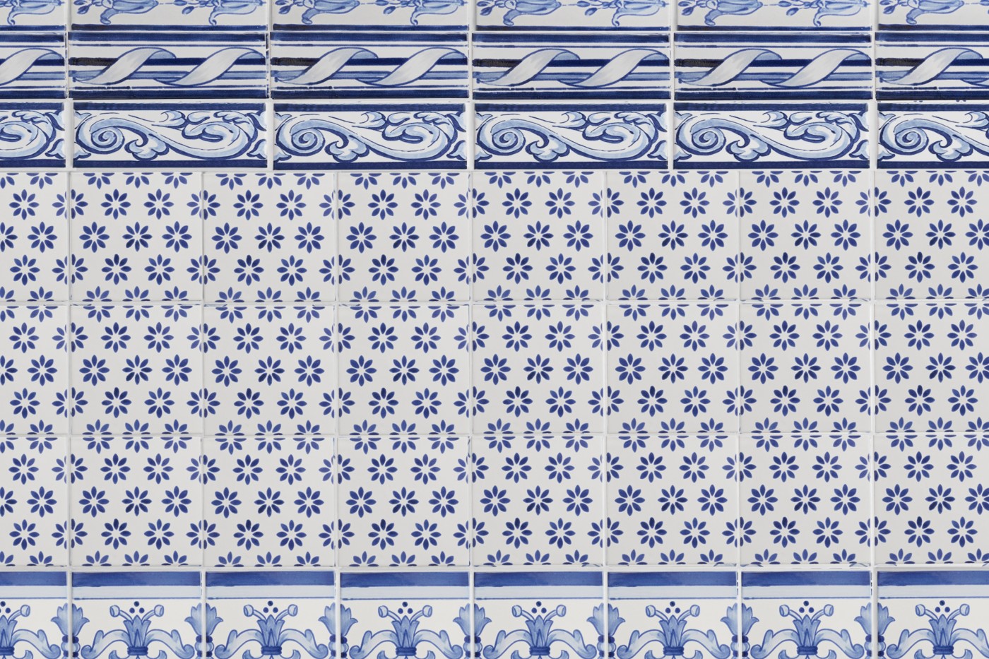 a blue and white tiled wall with decorative designs.