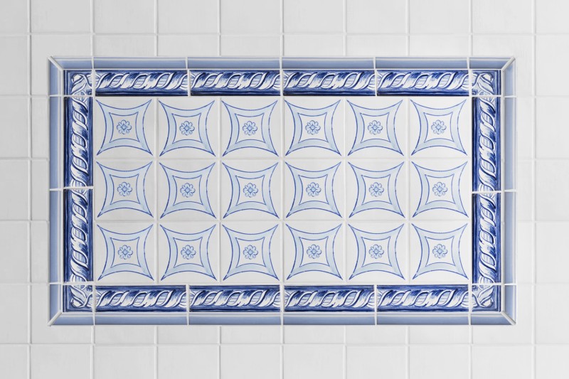 a blue and white tile design in a bathroom.