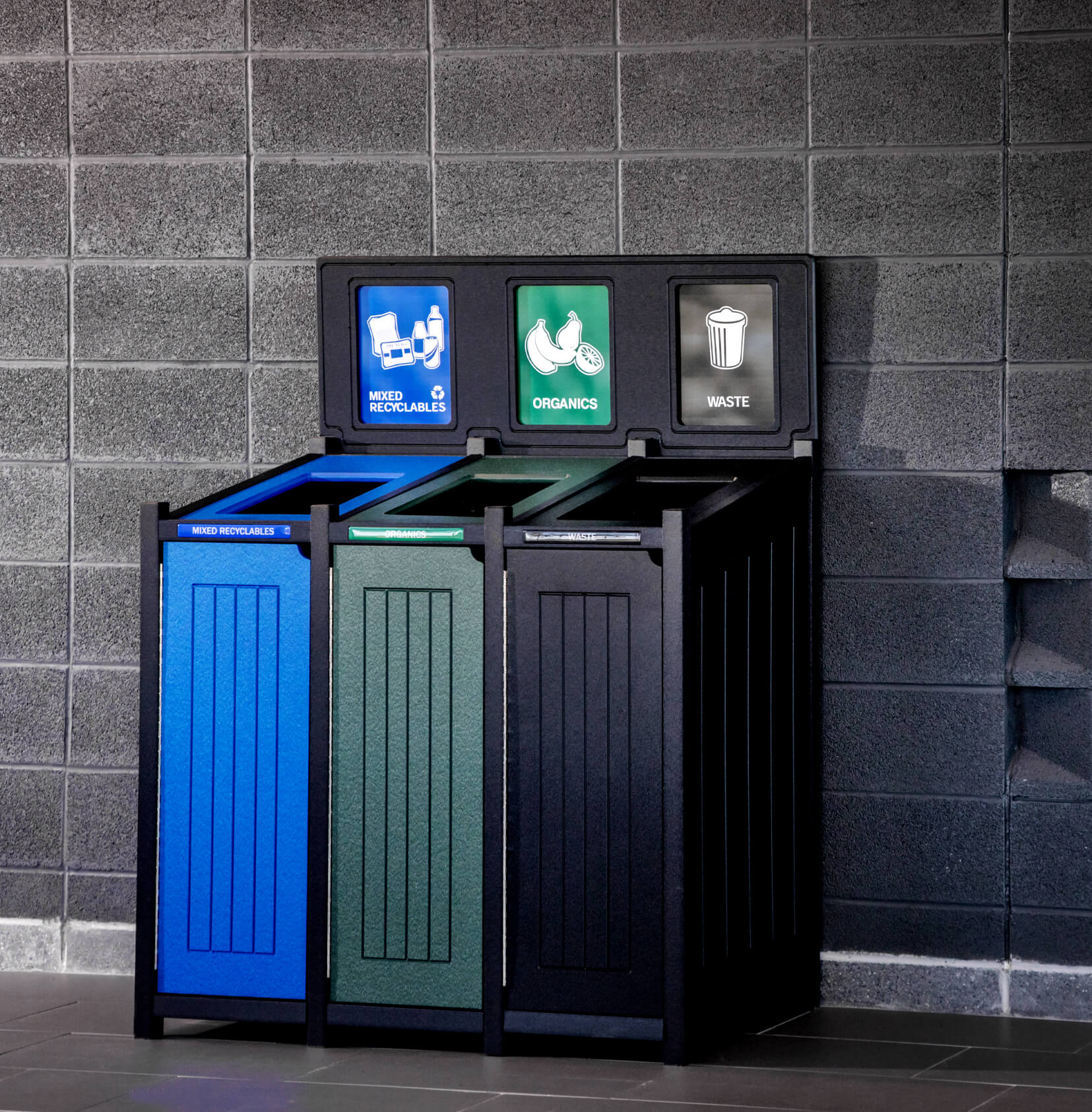centralized recycling and waste container in a busy college campus hallway