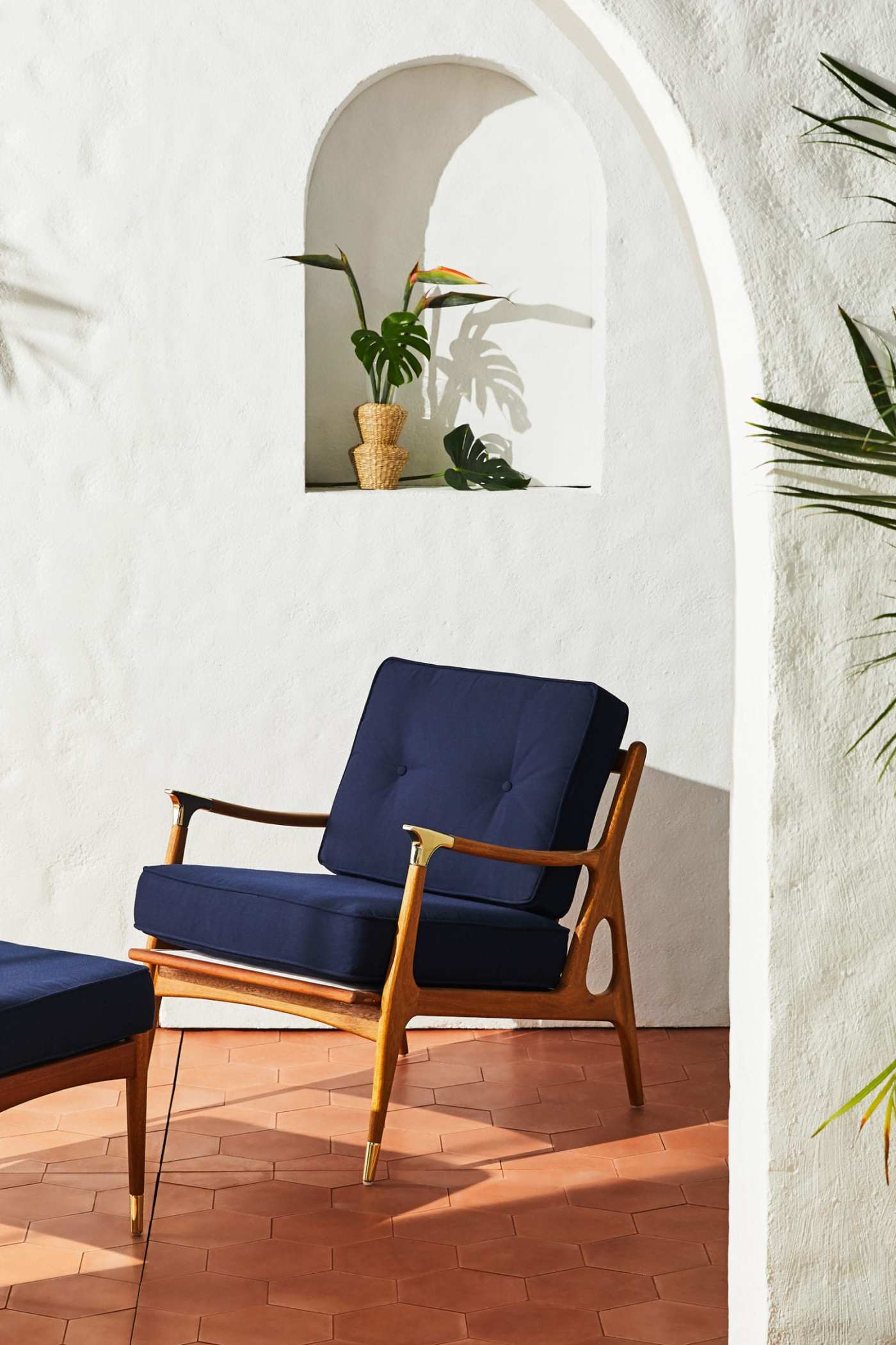 a blue lounge chair and ottoman on a patio.