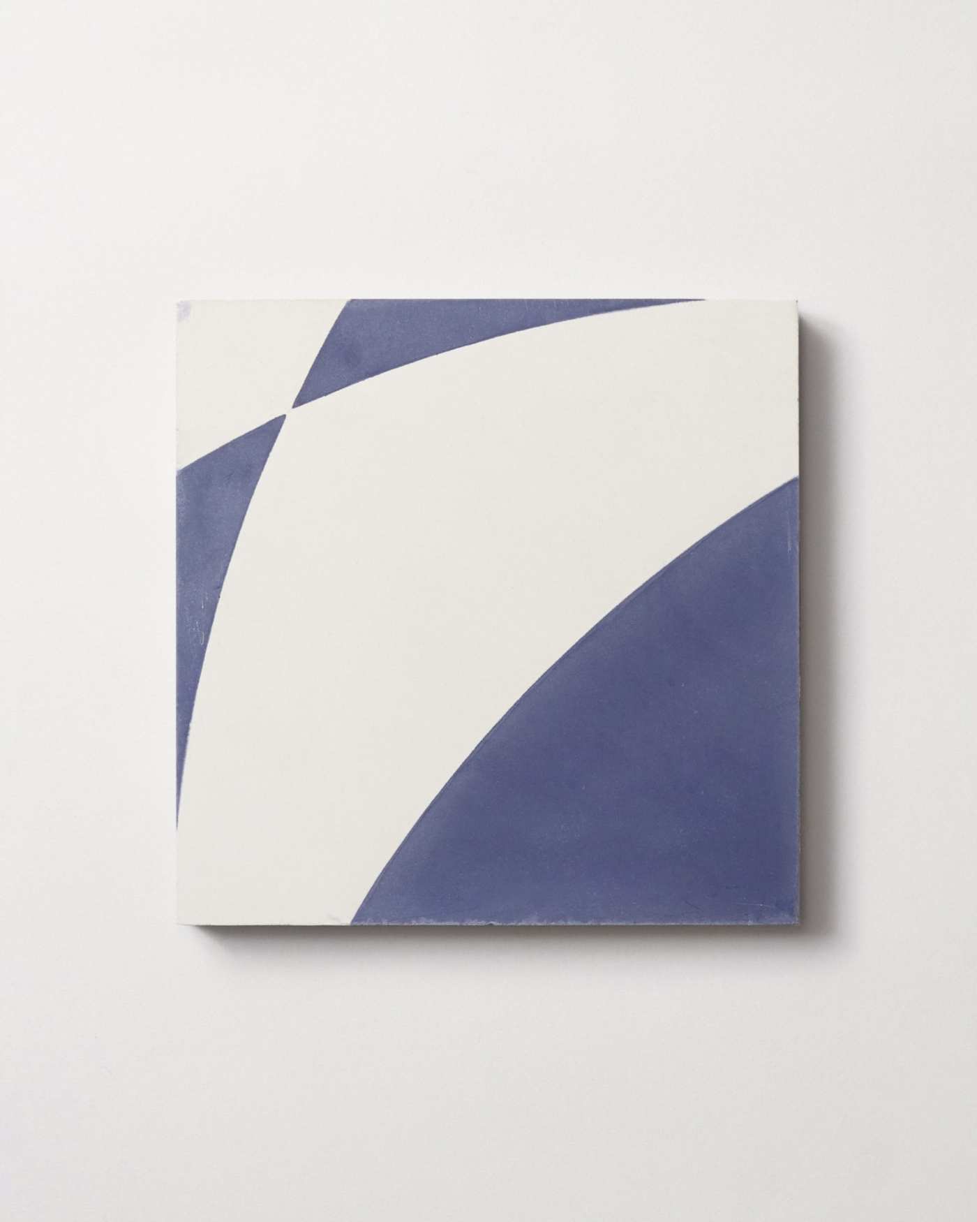 a blue and white tile on a white surface.