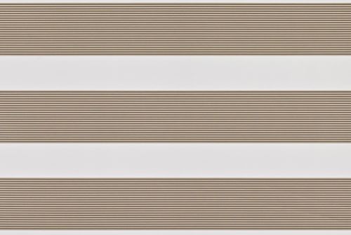 Dual-layer zebra roller blind lowered, alternating beige textured slats and white sheer bands; partially filtering light across a neutral interior wall, producing soft, evenly diffused daylight.