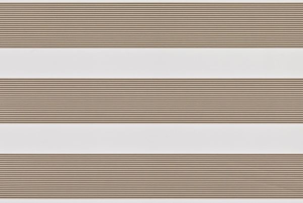 Dual-layer zebra roller blind lowered, alternating beige textured slats and white sheer bands; partially filtering light across a neutral interior wall, producing soft, evenly diffused daylight.