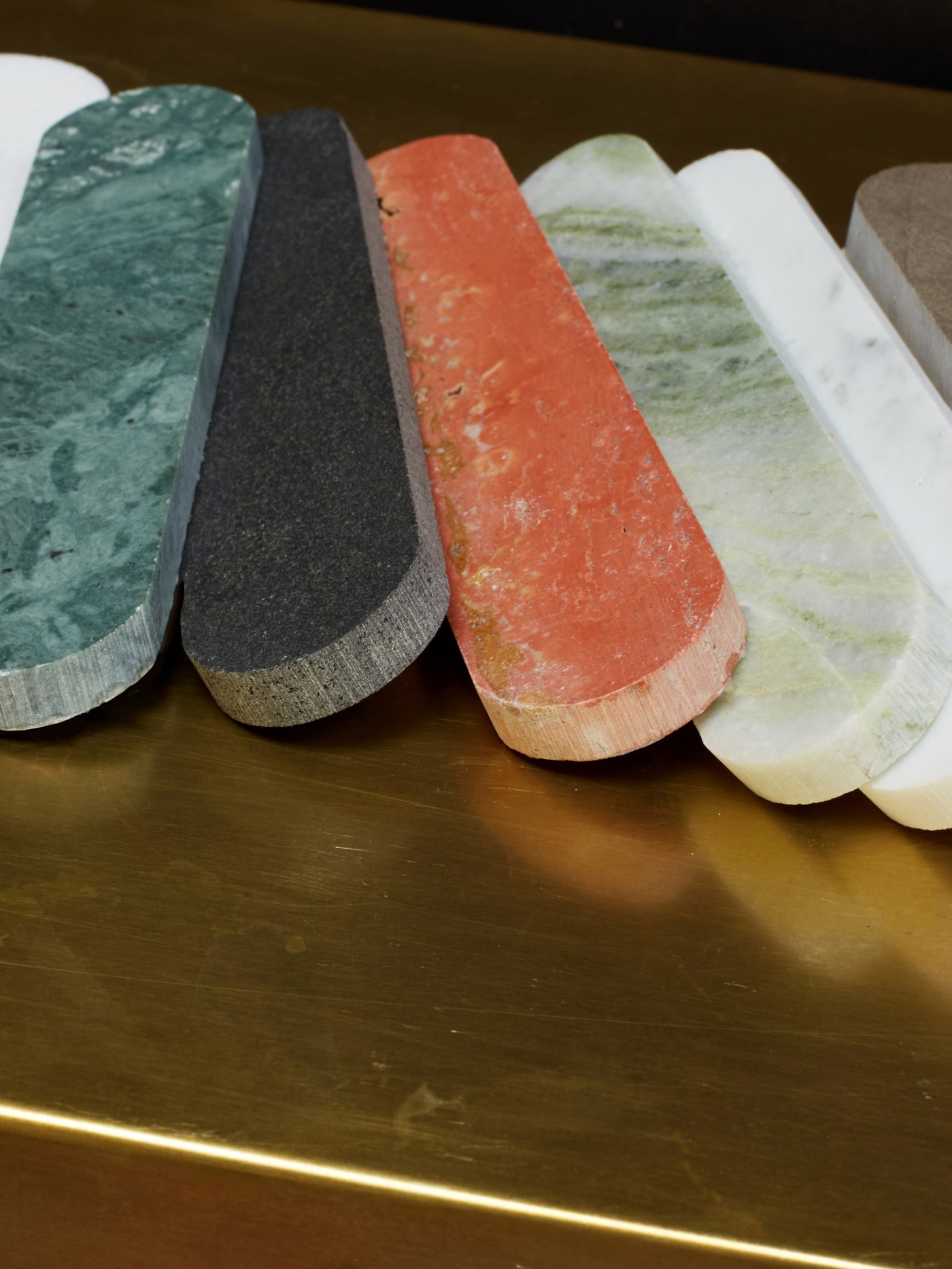 a group of different colored marbles on a table.