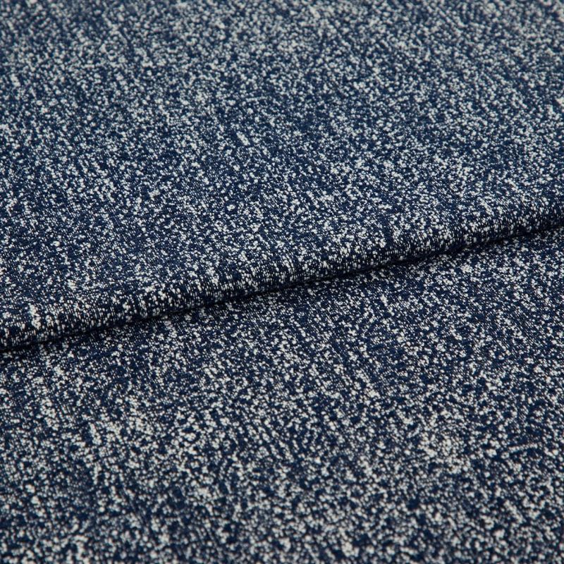 Folded speckled navy woven fabric close-up showing dense white fleck pattern; fabric lies layered and slightly overlapping, highlighting textured weave under soft studio lighting on a neutral background.