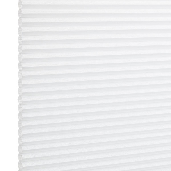 White pleated cellular window shade, fully lowered and closed with regular horizontal honeycomb cells; filtering diffuse light in a bright, minimal interior setting.