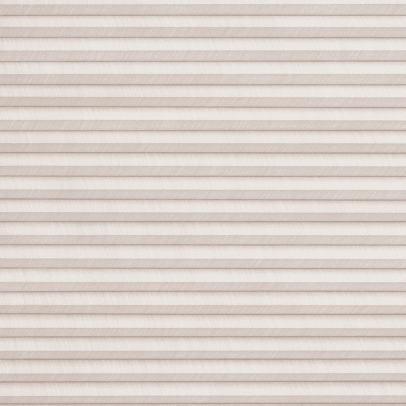 Beige textured pleated cellular blind, fully lowered and closed with horizontal folds; filtering soft, diffused daylight and obscuring the outside in a neutral interior setting.