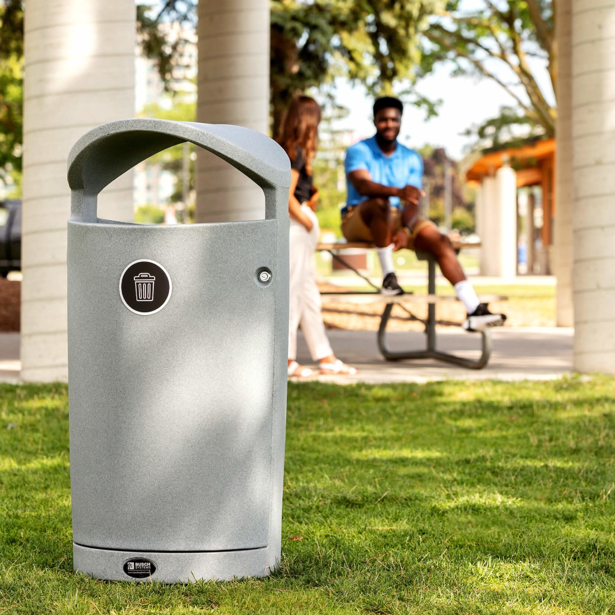 outdoor waste container made from durable LDPE at municipal park with people in the background