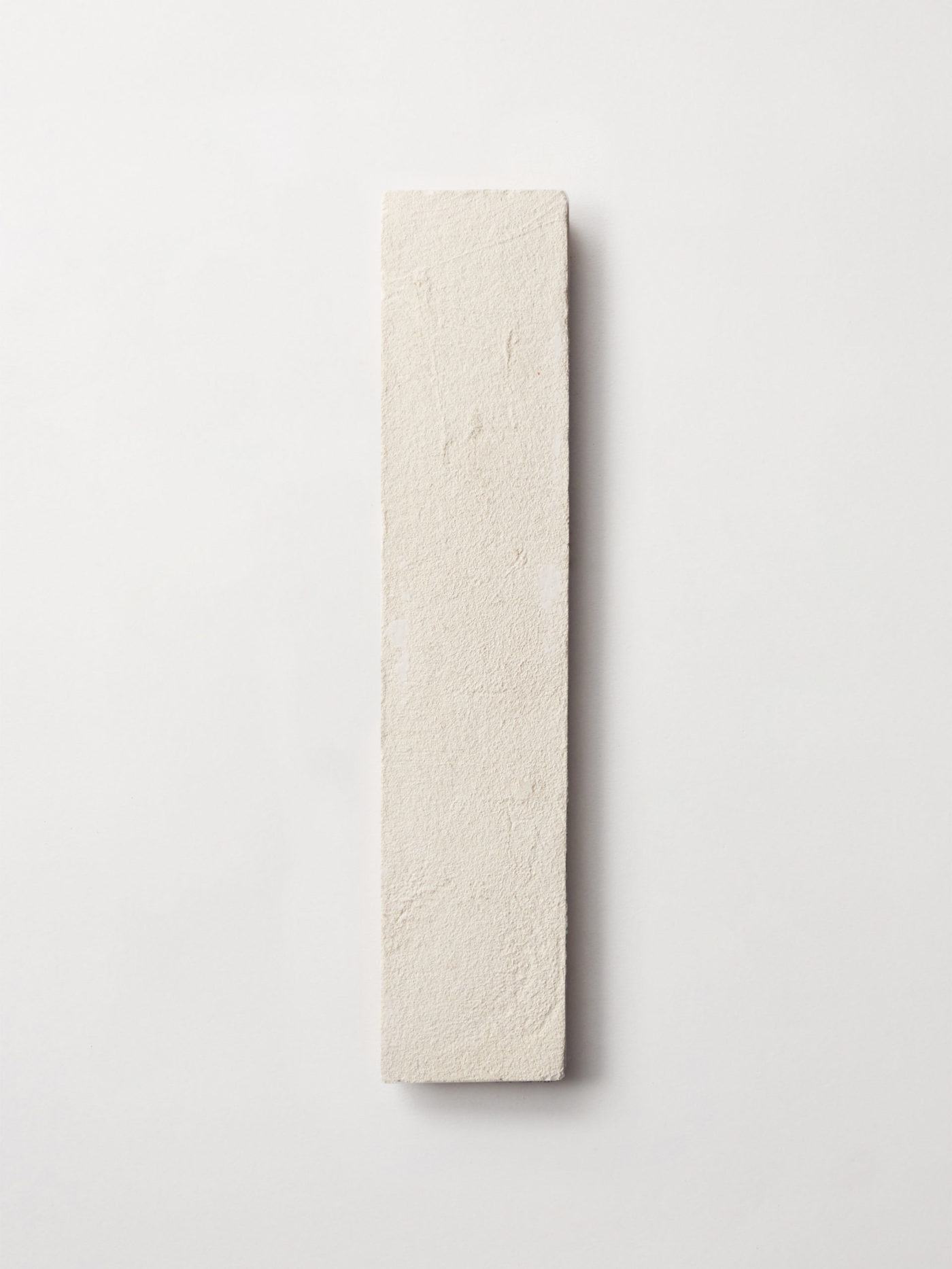 a white rectangle tile on a white surface.