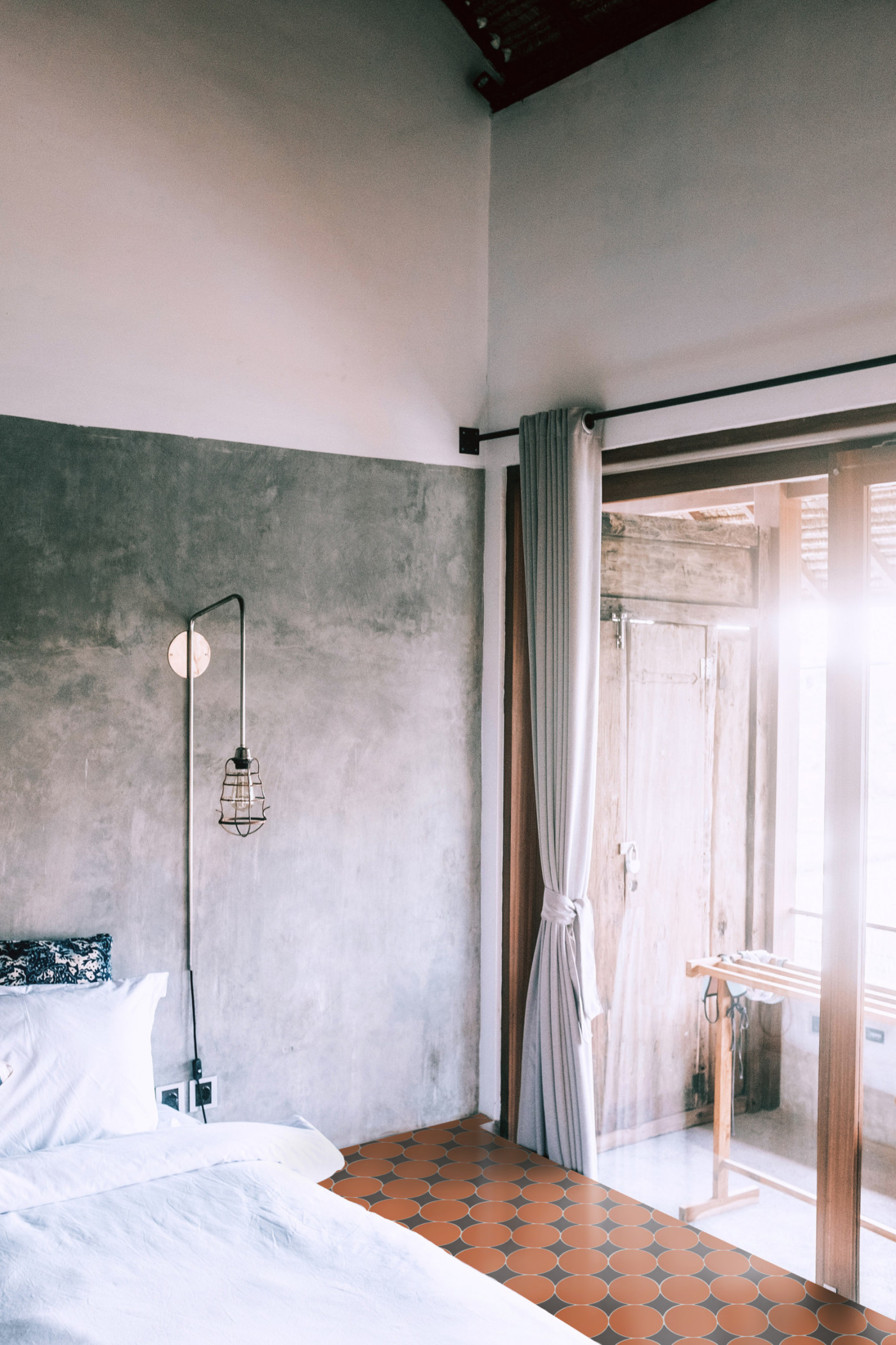 a bedroom with a bed and a sliding glass door.