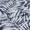 Navy textile printed with pale-blue palm-leaf motif, folded across the center producing an overlapping seam; close-up studio view highlighting fabric texture and even, soft lighting.