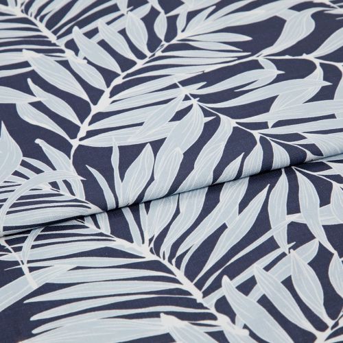 Navy textile printed with pale-blue palm-leaf motif, folded across the center producing an overlapping seam; close-up studio view highlighting fabric texture and even, soft lighting.