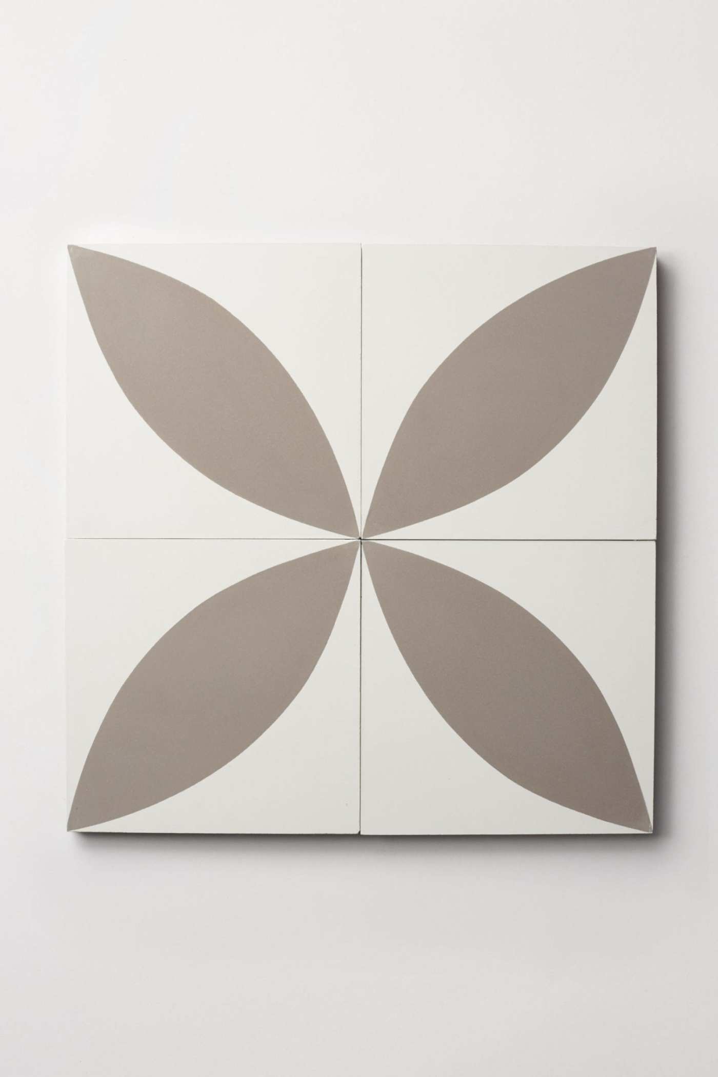 four white and grey tiles forming a flower design.