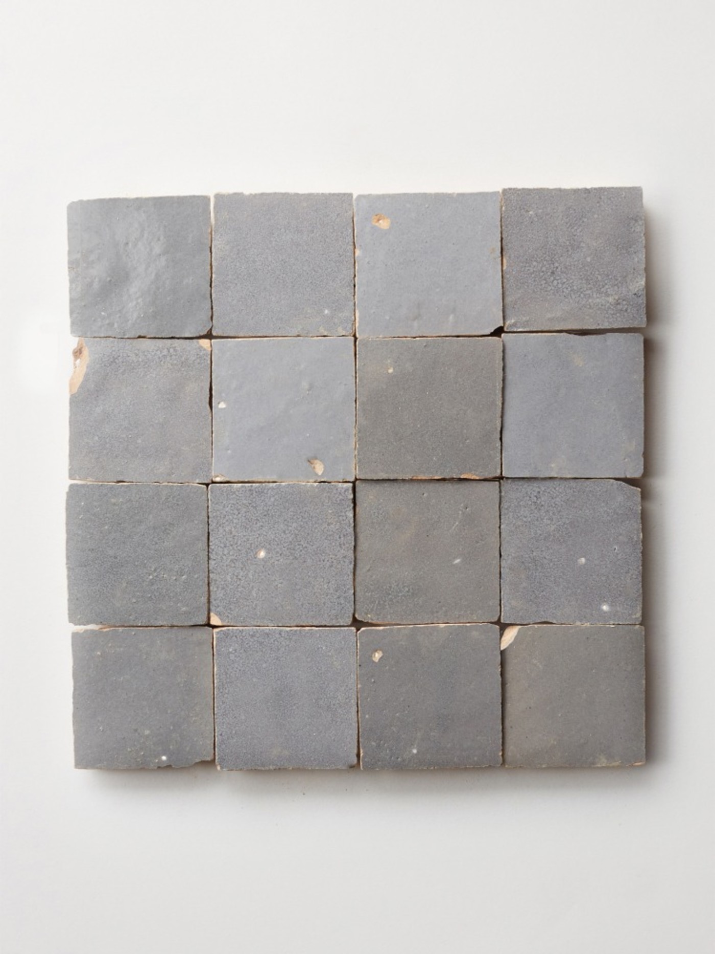 grey square tiles arranged on a white surface.