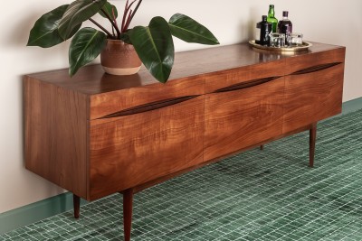 a wooden sideboard with a potted plant on it.