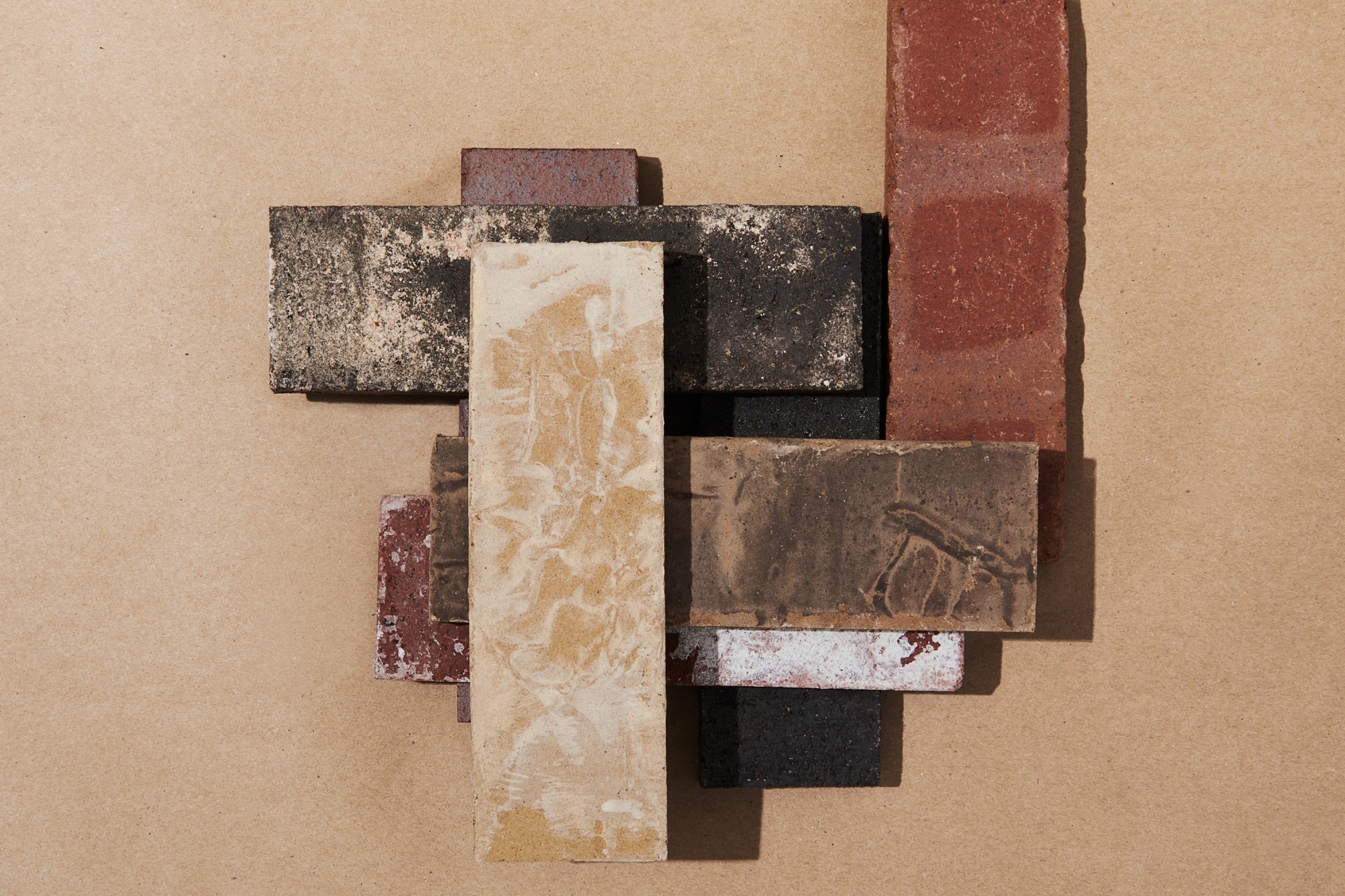 a group of different colored bricks stacked on a beige surface.