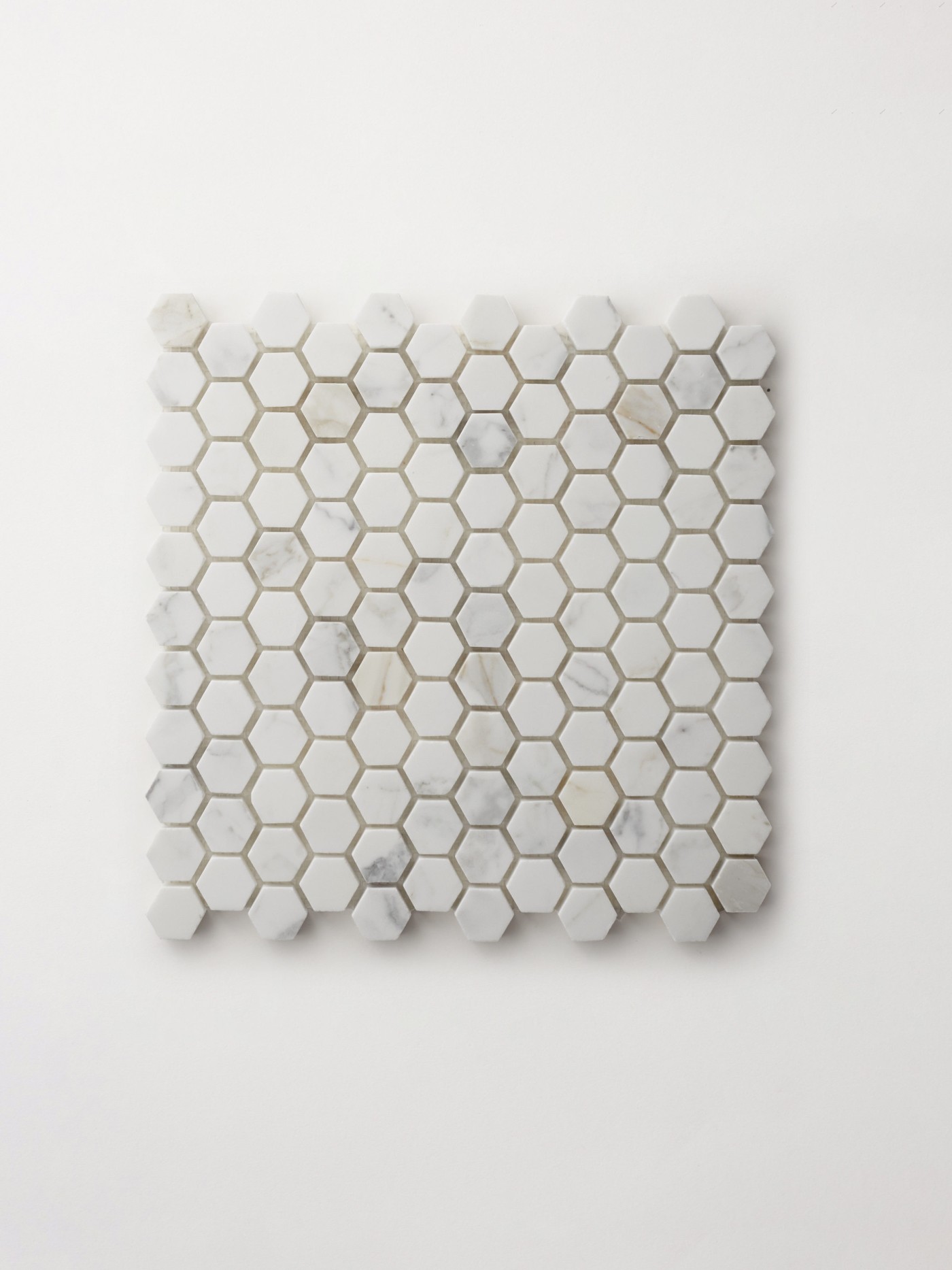 a white hexagonal mosaic tile sheet on a white background.