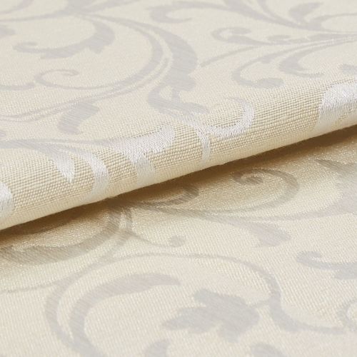 Cream damask curtain fabric swatch, folded with raised woven scroll motifs, reflecting subtle sheen; close-up macro view showing textured weave and soft studio lighting on a neutral surface.
