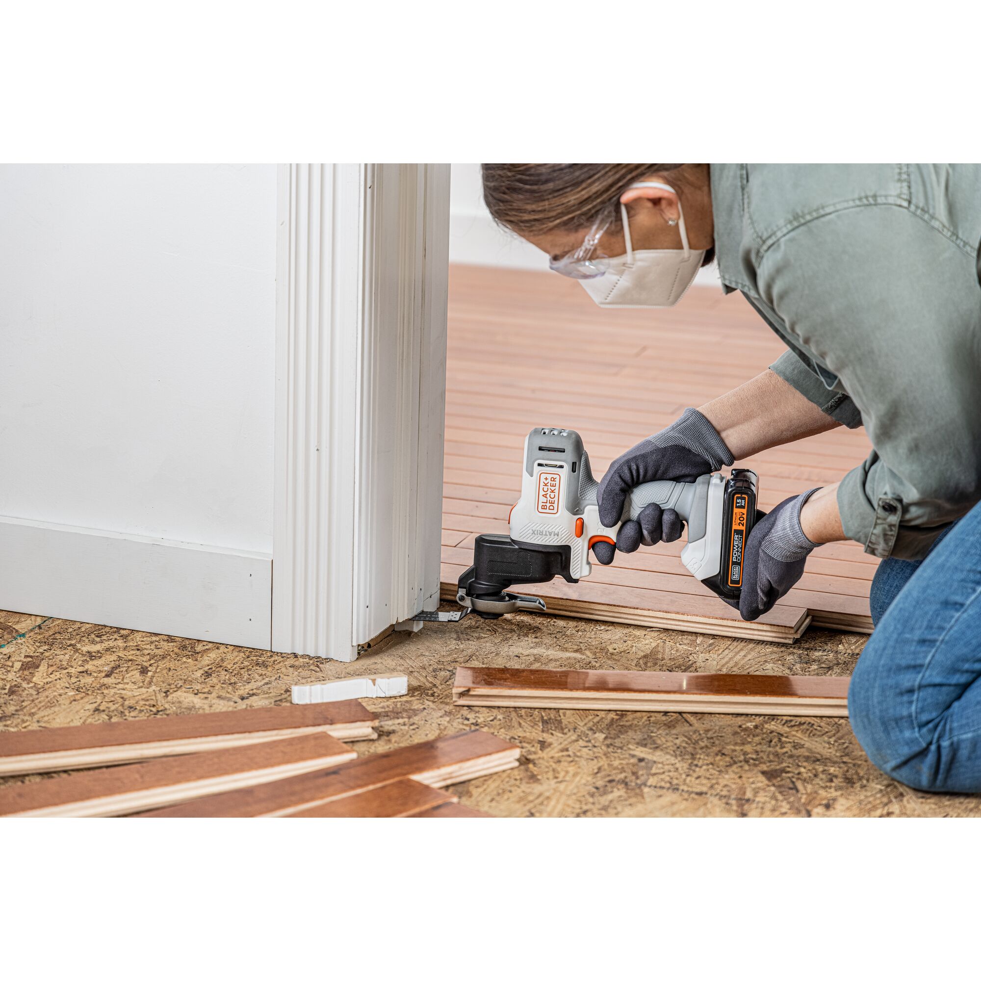 Person uses the BLACK+DECKER MATRIX oscillating multi-tool attachment to cut trim and install flooring underneath