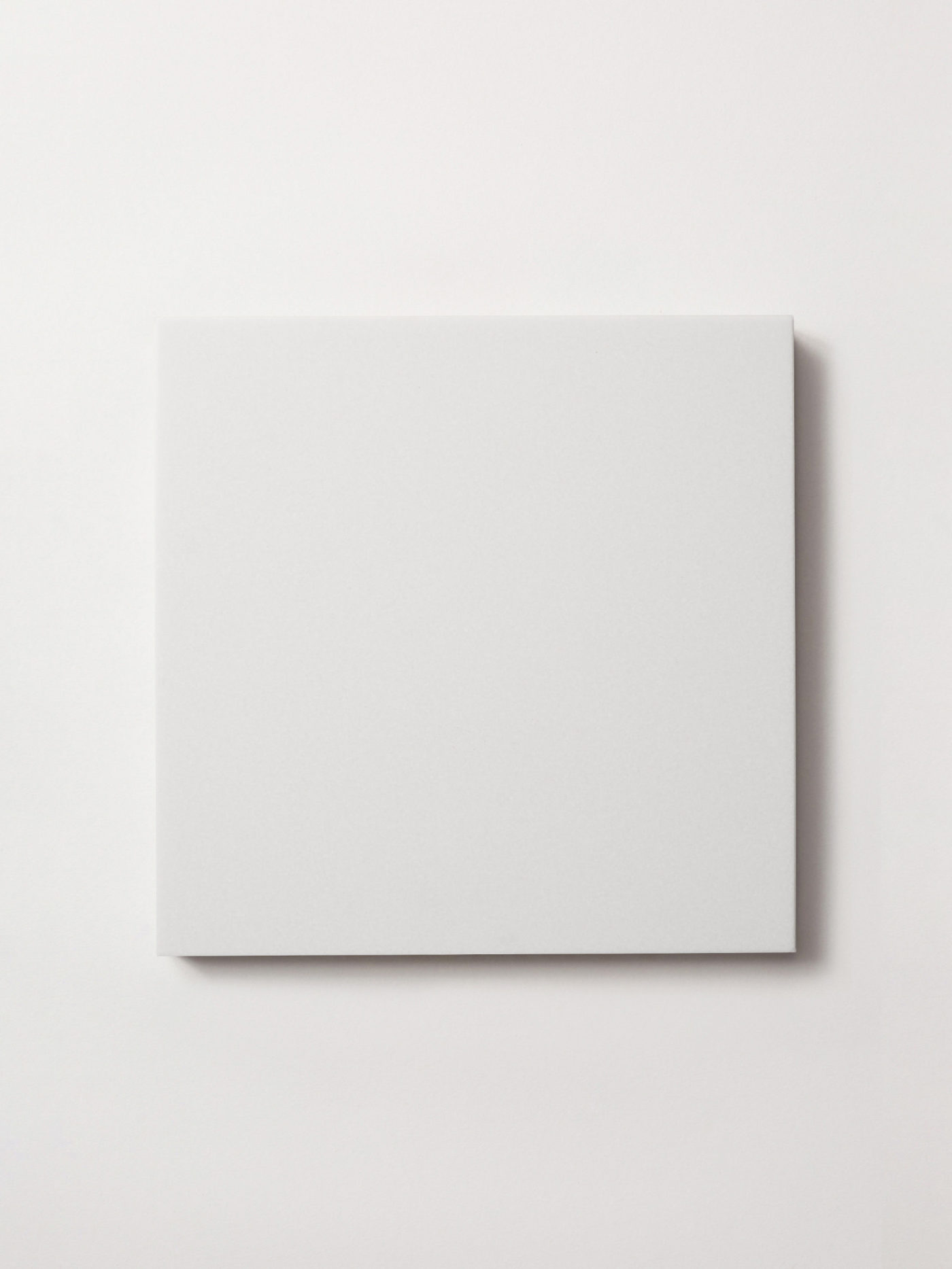 a square white tile on a white background.