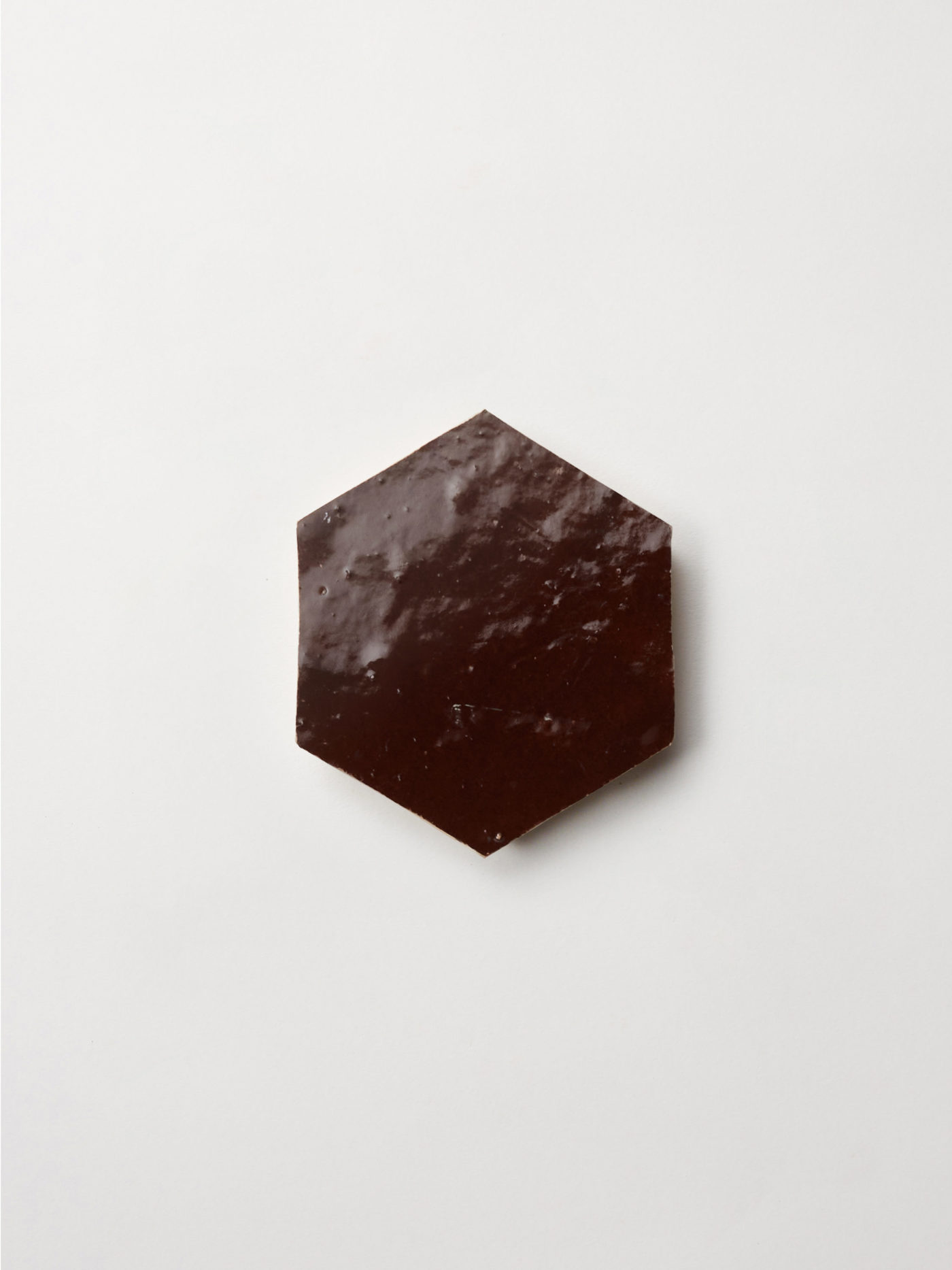 a brown hex tile on a white background.