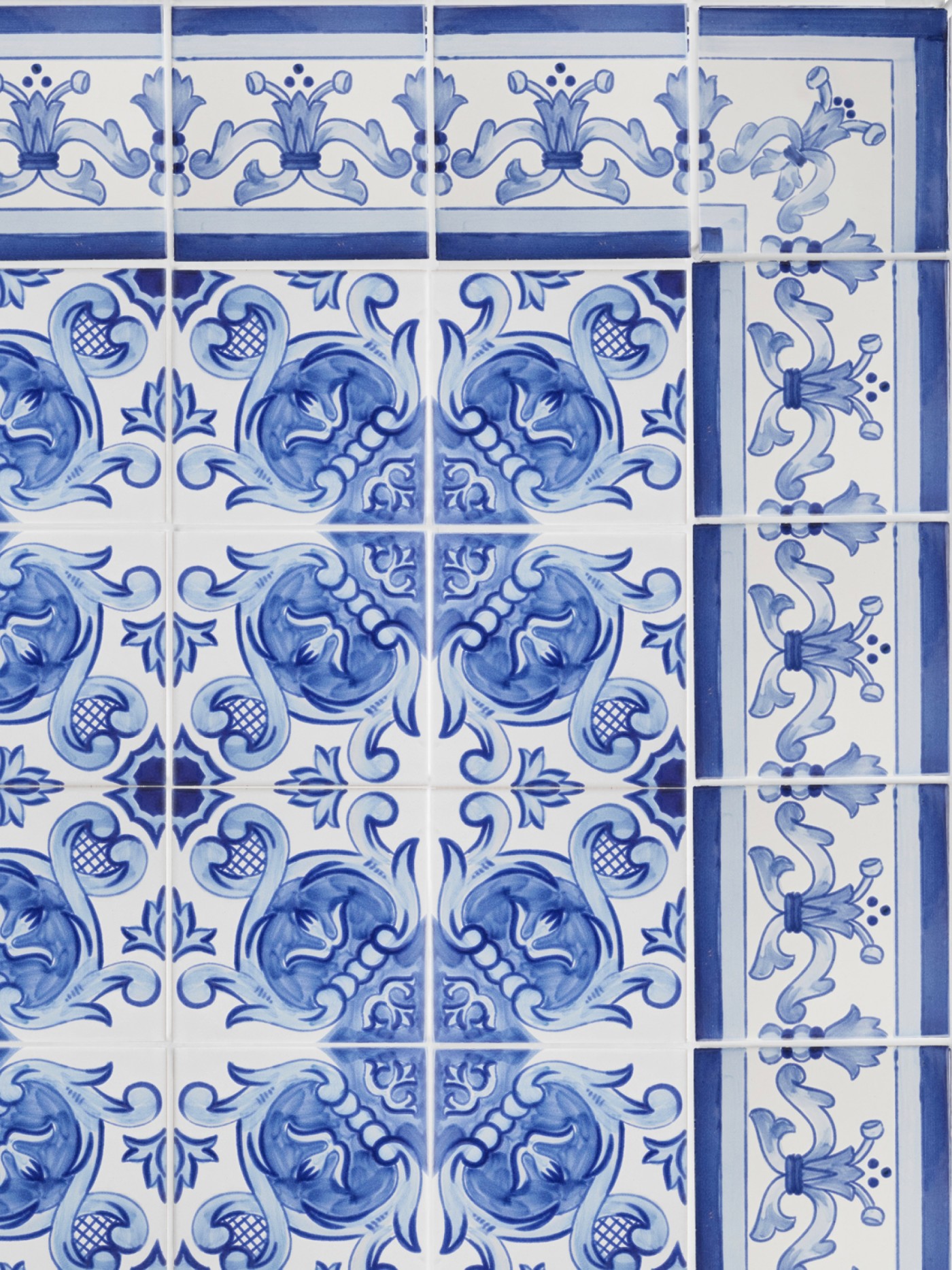 an assortment of blue and white tiles with ornate designs.