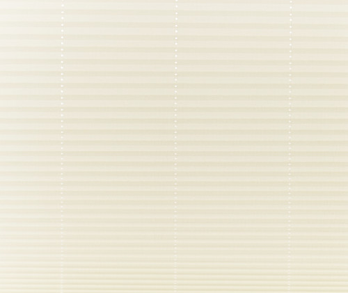Beige pleated cellular shades covering a window, fully lowered and closed with vertical bead cords visible; filtering soft, diffused daylight into a neutral-toned interior, obscuring any outside view.