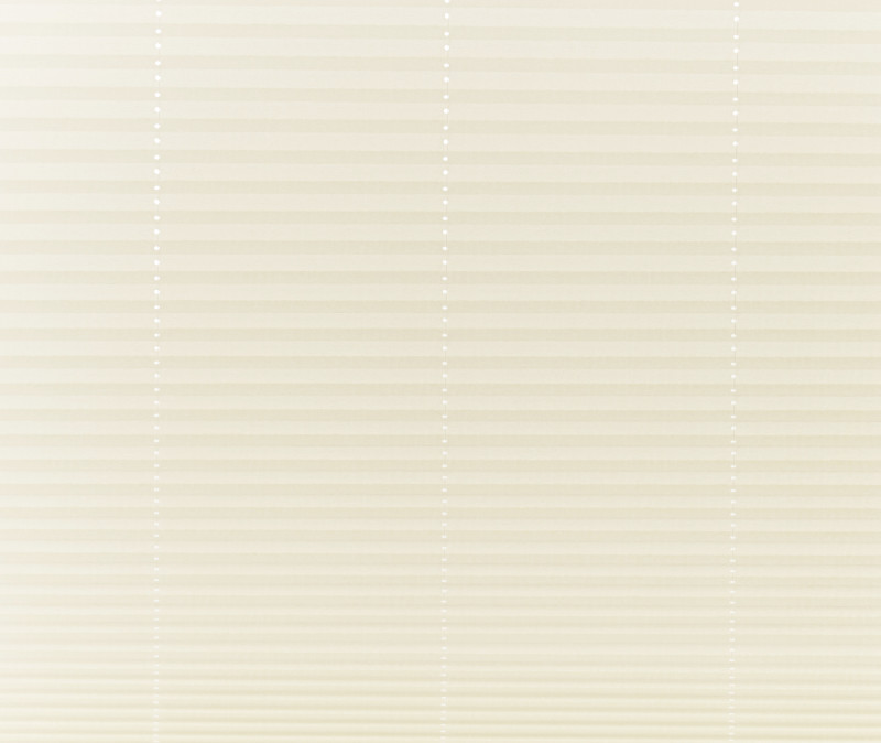 Beige pleated cellular shades covering a window, fully lowered and closed with vertical bead cords visible; filtering soft, diffused daylight into a neutral-toned interior, obscuring any outside view.