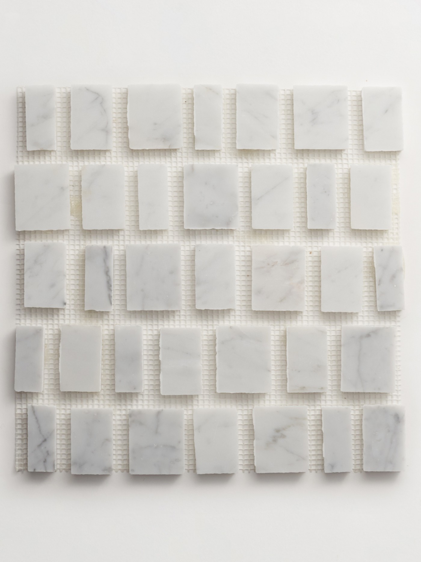 a white marble mosaic tile on a white surface.