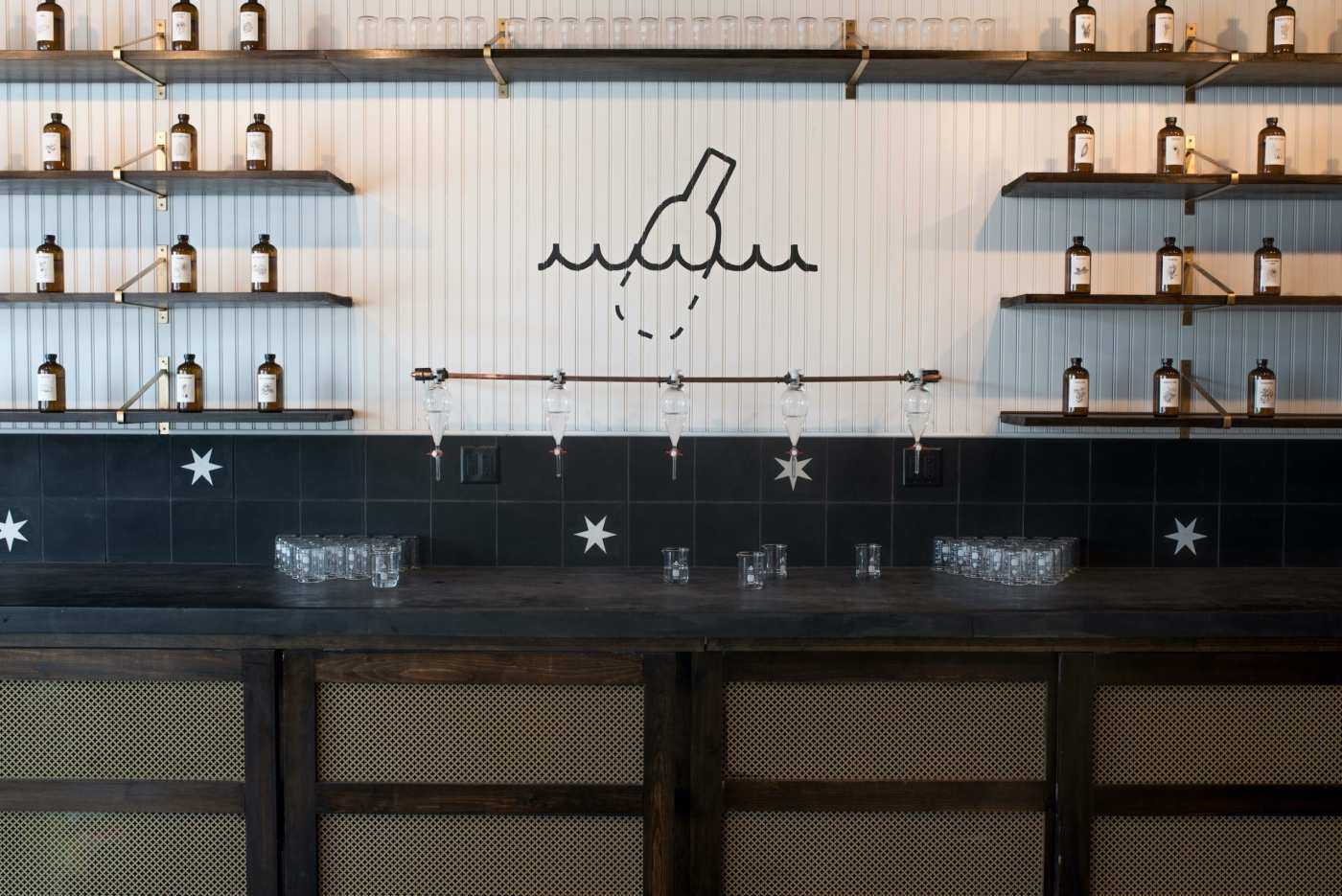 a bar with shelves filled with bottles.