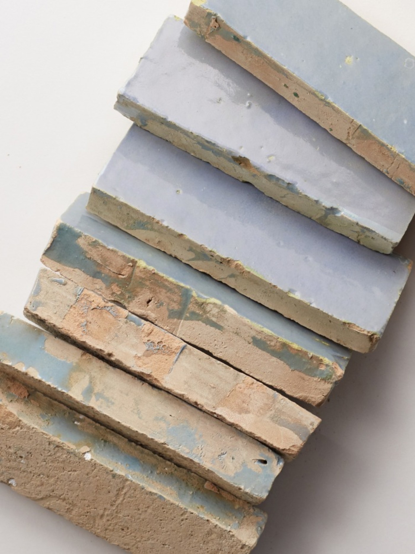 a stack of blue tiles on a white surface.