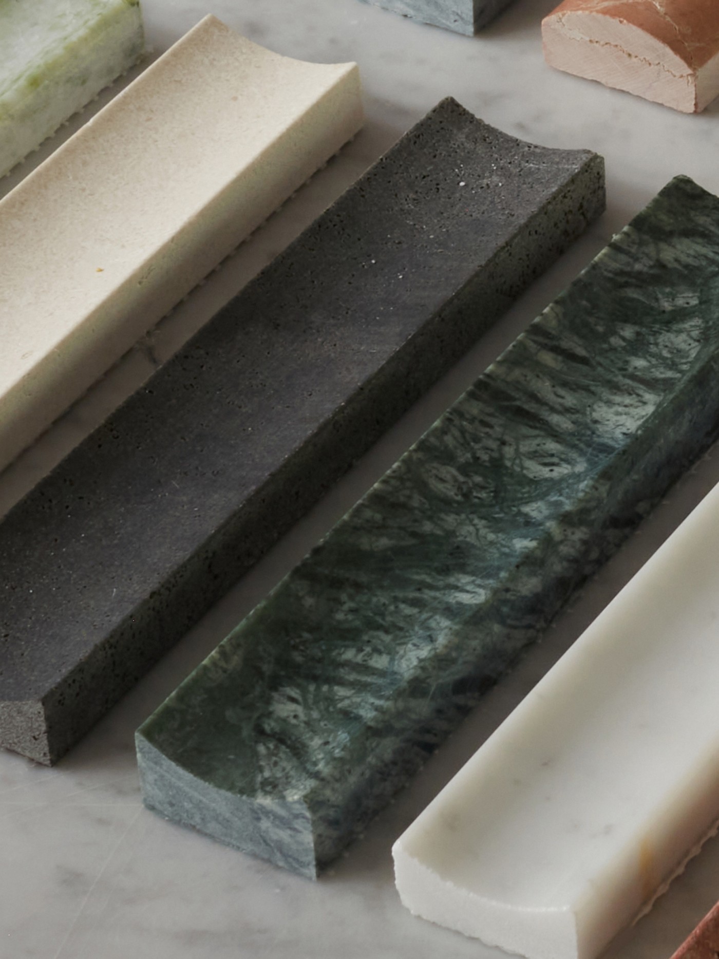 a row of different colored marble slabs on a marble table.