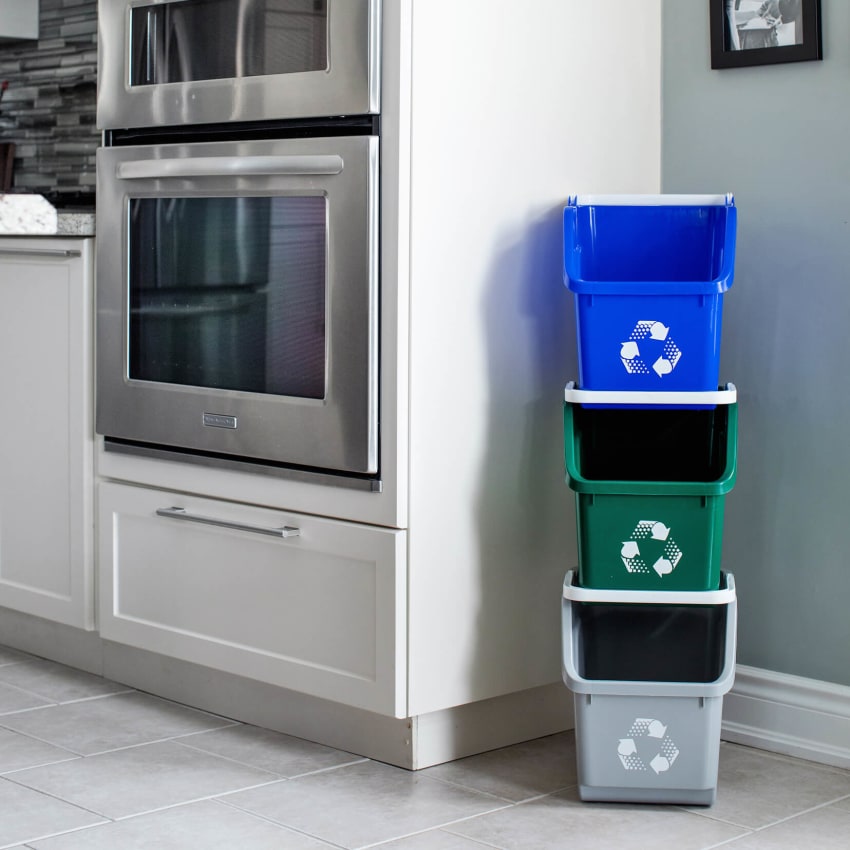 color-coded plastic stacked recycling bins in a modern kitchen