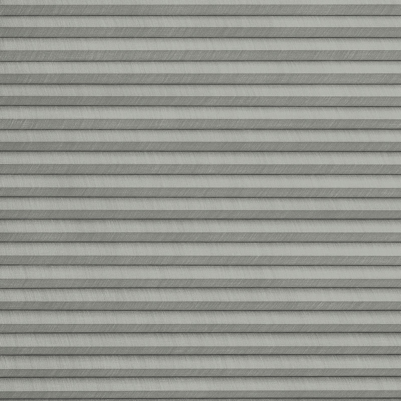 Grey pleated cellular blinds across the frame, closed with uniform horizontal folds and textured fabric; blocking view and softly diffusing light in a neutral, minimally lit interior.
