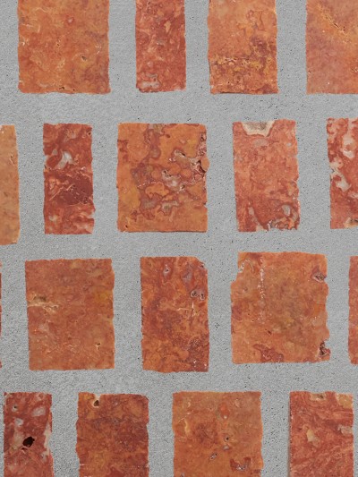 a tiled wall with a lot of red bricks.