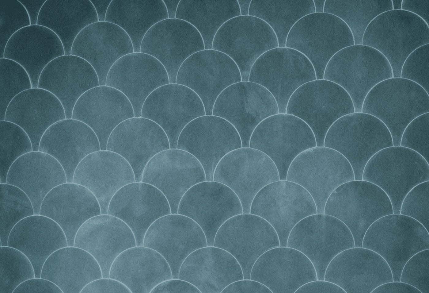 a surface covered with blue scallop shaped tiles.