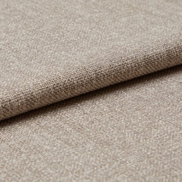 Beige woven upholstery fabric (tight basket weave), folded over an edge, displaying textured threads and slight sheen; close-up on a flat surface under soft, diffused lighting.
