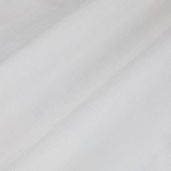 White sheer linen curtain, diagonally folded with visible weave, draping and softly filtering daylight; fills a neutral interior space with diffuse light and subtle shadows.