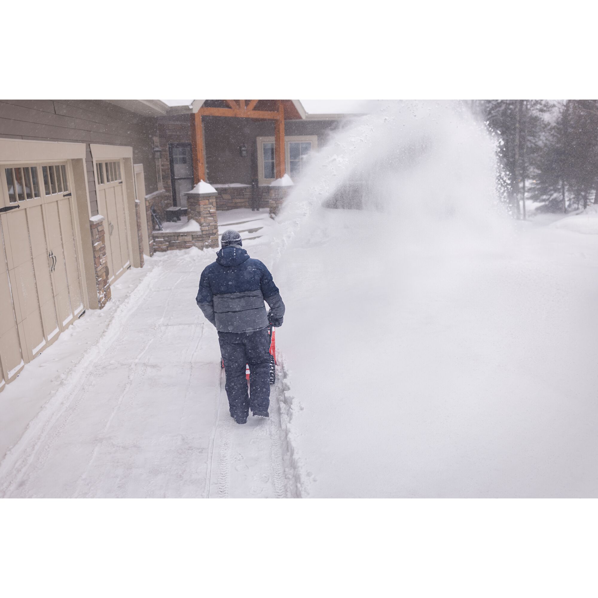 CRAFTSMAN Select 24 Snowblower clearing snow off driveway near garage